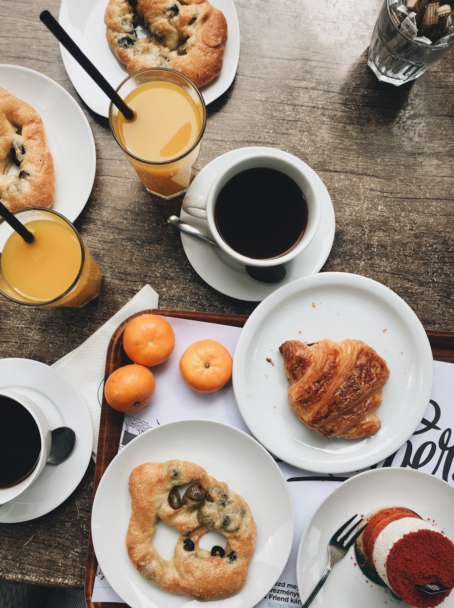 A breakfast tray with coffee, orange juice, clementines and a croissant